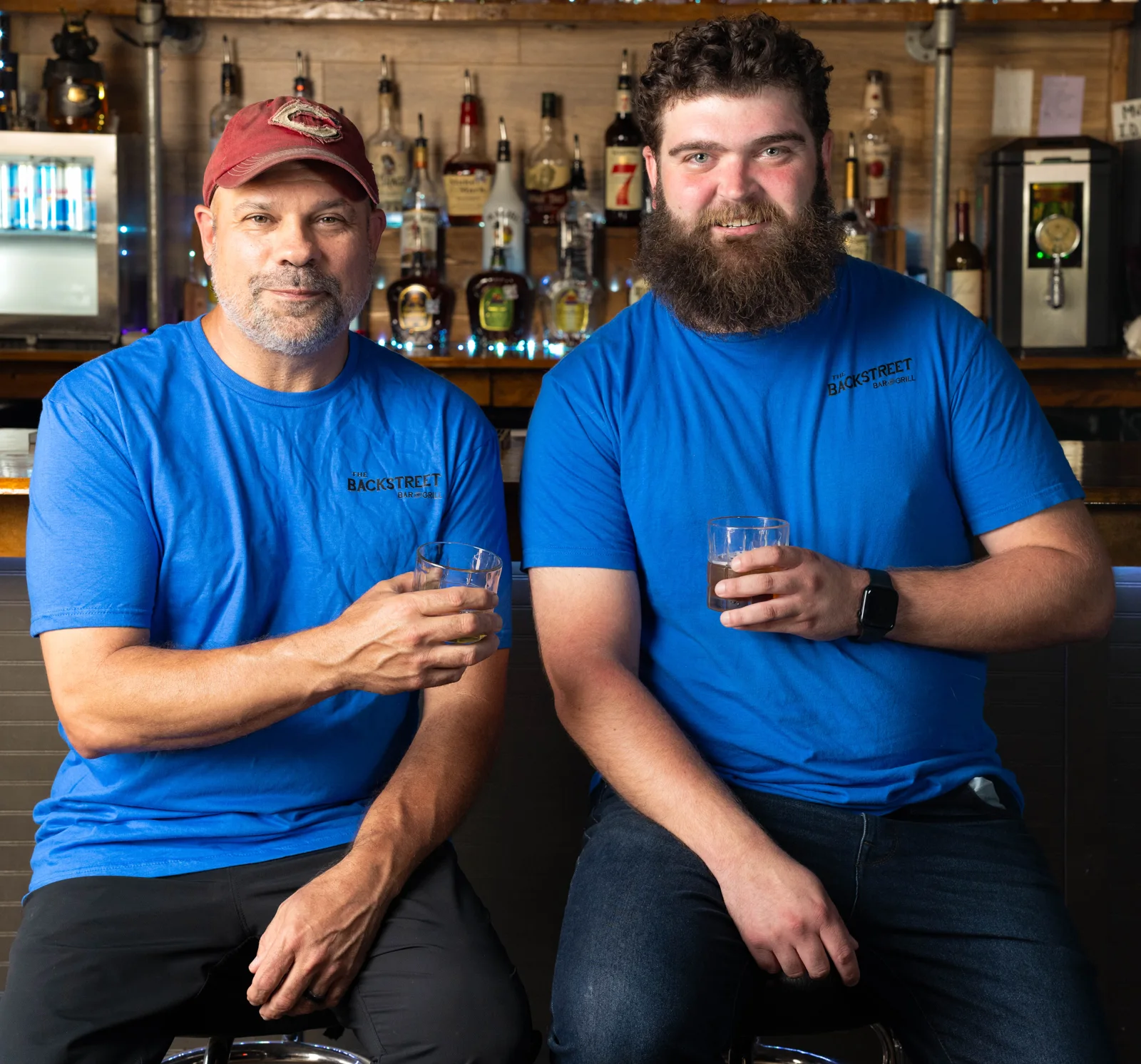Two people smiling together with drinks at Backstreet Bar & Grill